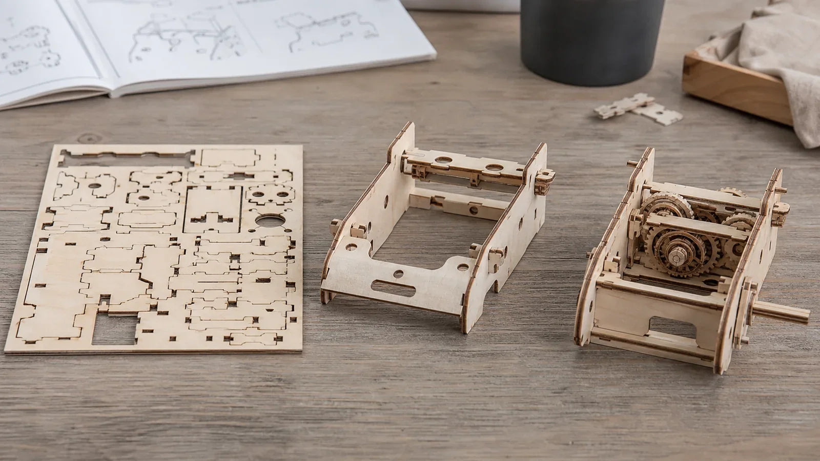 Wooden model shown as a laser-cut sheet, basic frame, and assembled mechanism